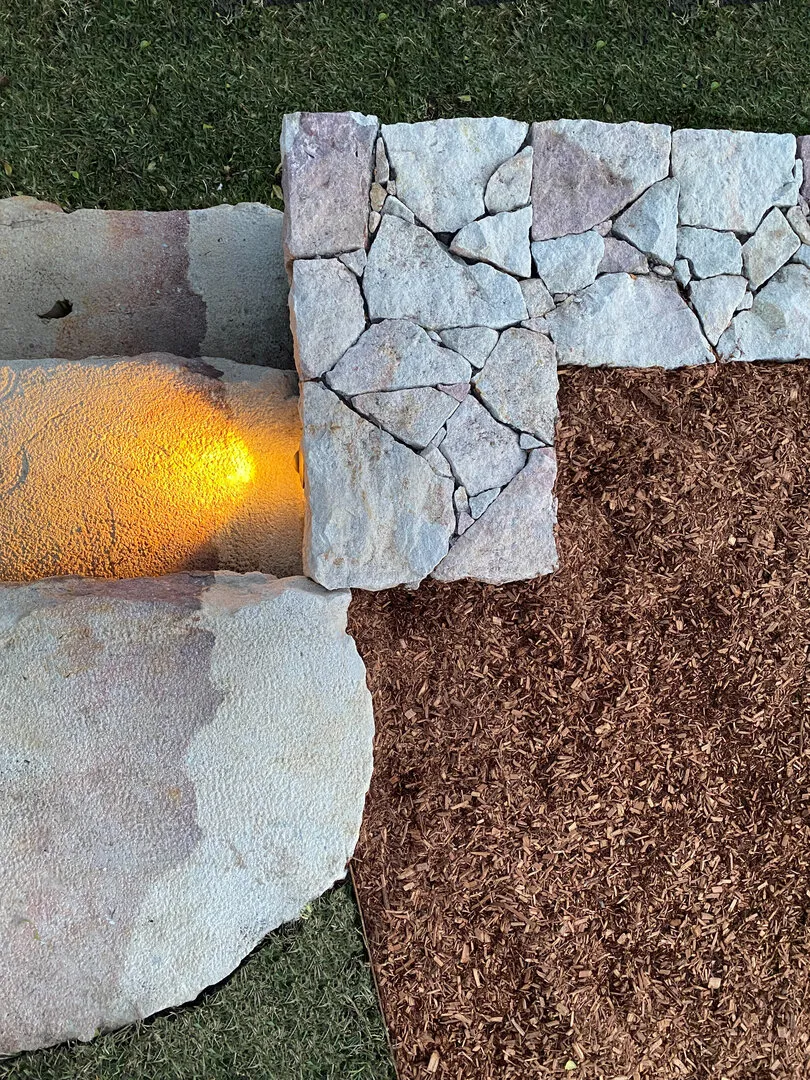 Stone path with mulch and grass landscaping
