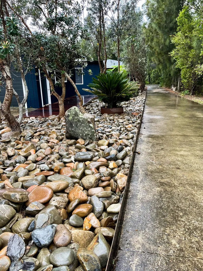 Rock garden by house and driveway