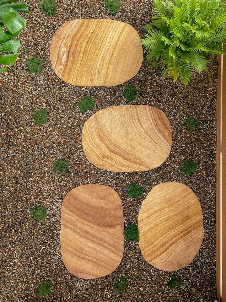 Flat stone pathway with surrounding greenery.