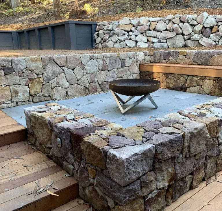 Stone fire pit in a rustic patio setting.