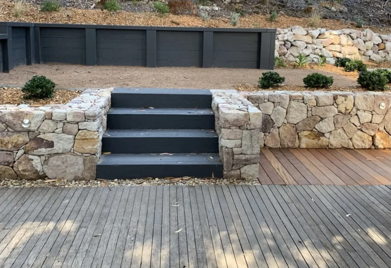 Stone staircase leading to tiered garden beds
