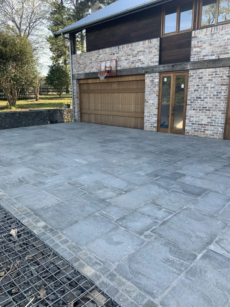 Brick garage with attached basketball hoop.