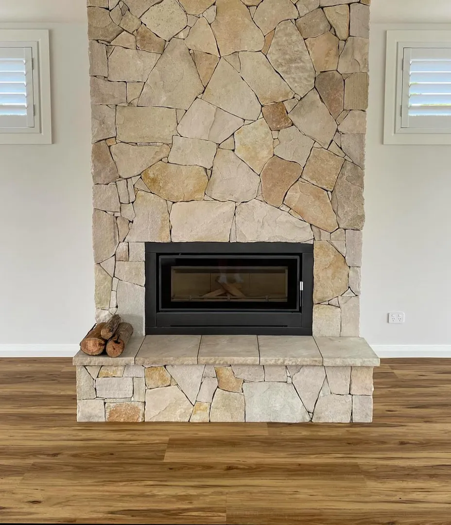 Stone fireplace with wood floor and logs