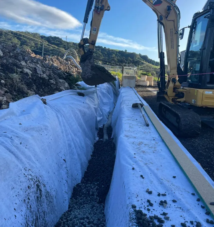 Excavator digging trench for construction site.
