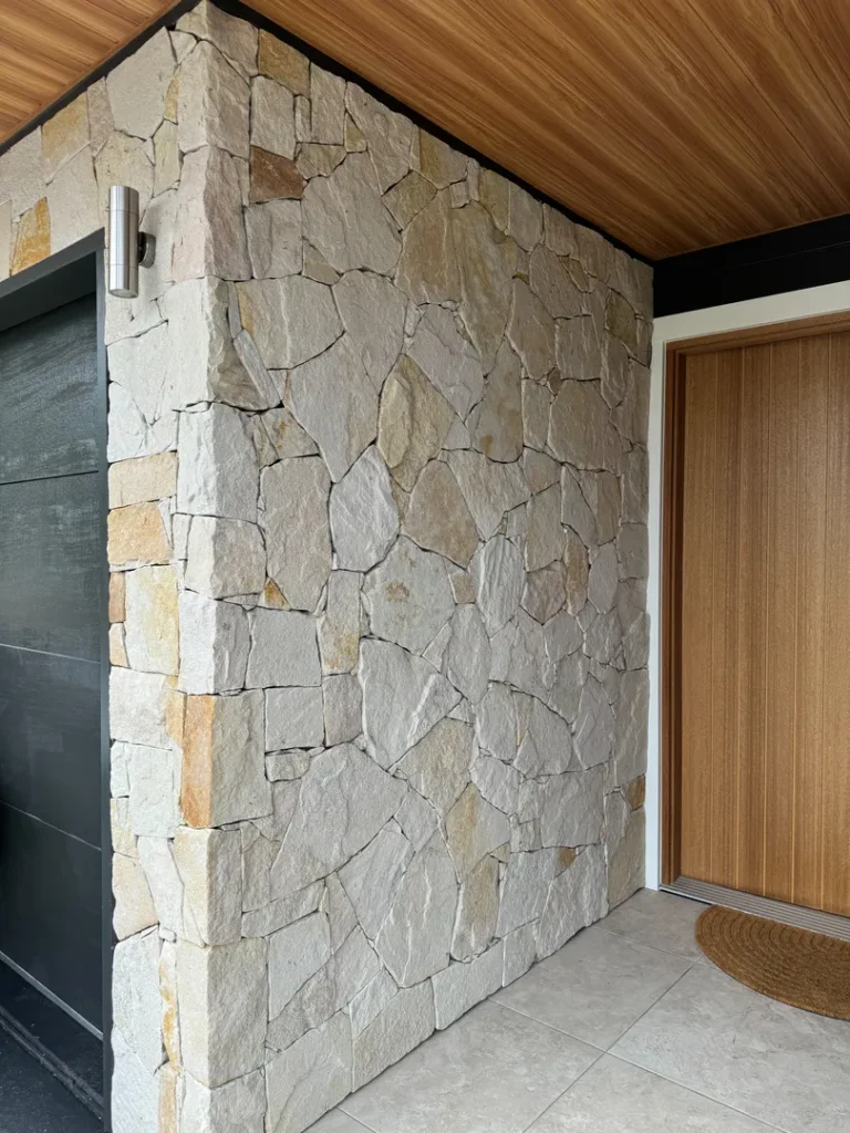Stone wall with wood door and ceiling.
