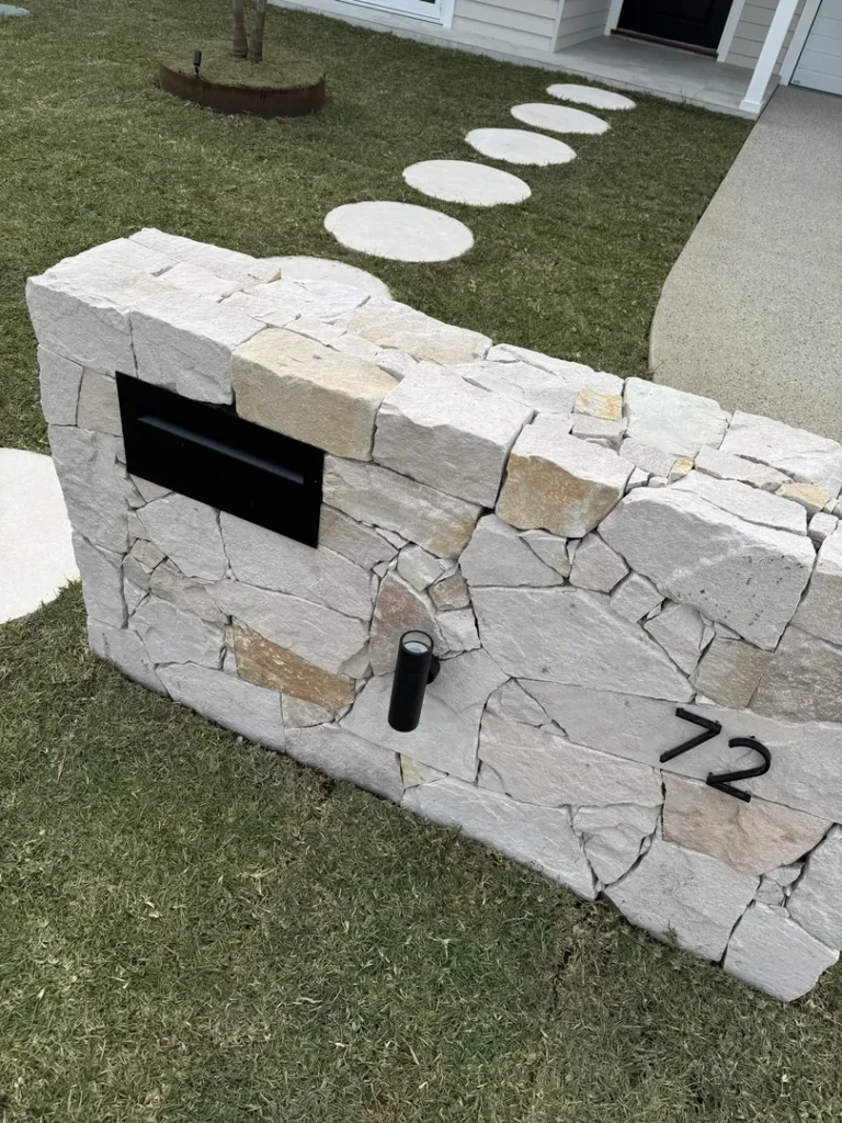 Stone wall with mailbox and house number 72