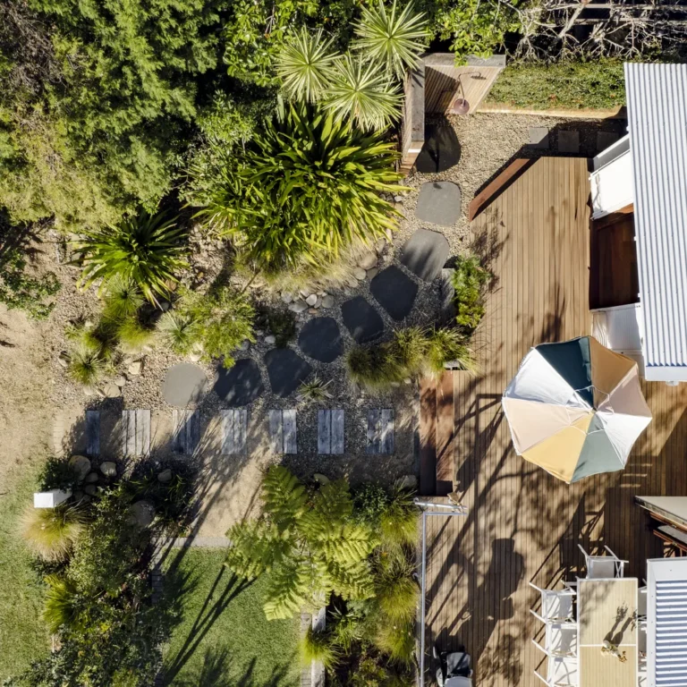 Aerial view of landscaped backyard with wooden deck