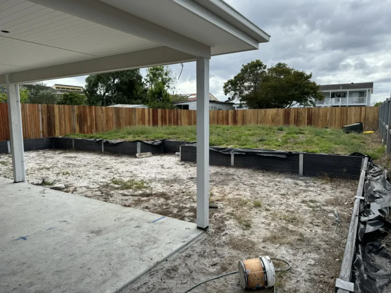 Backyard renovation with new wooden fence and patio