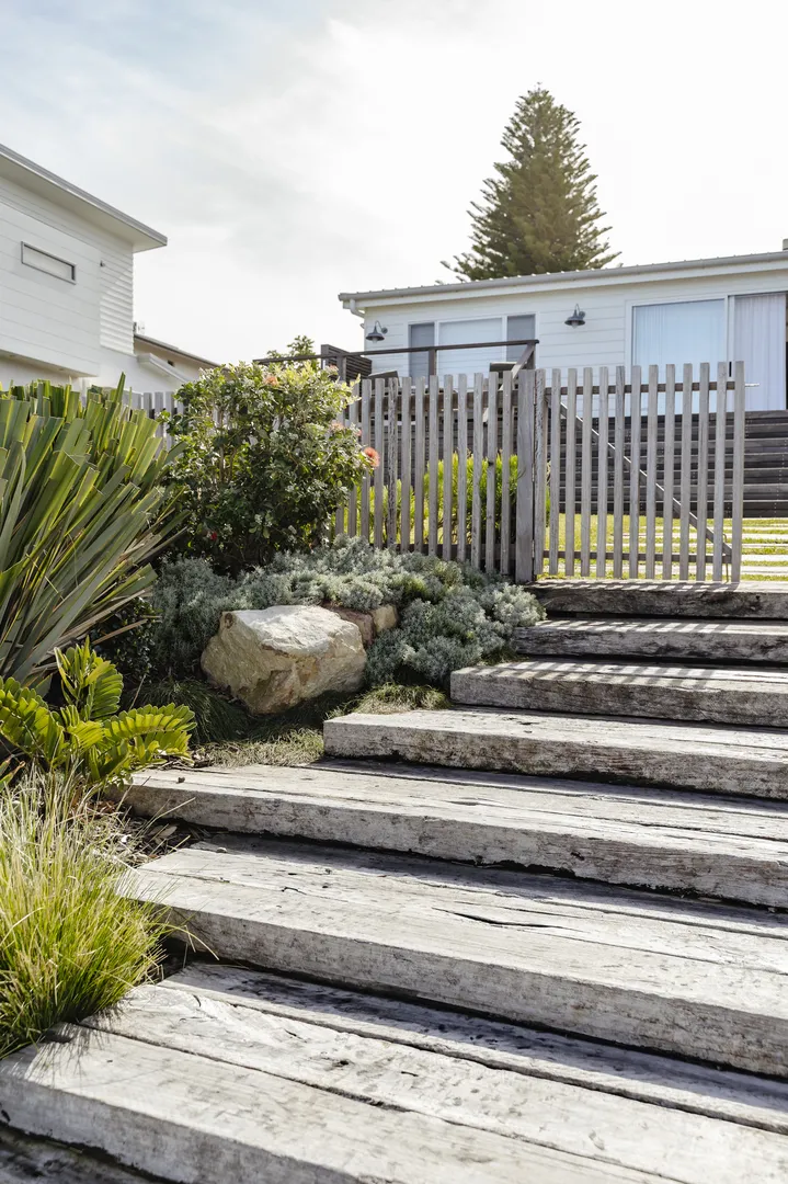 Wooden steps leading to modern white house