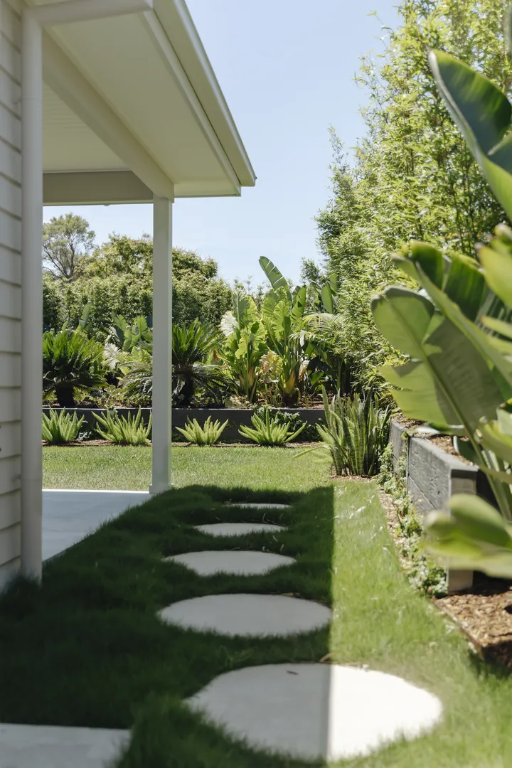 Stepping stone path beside lush tropical garden