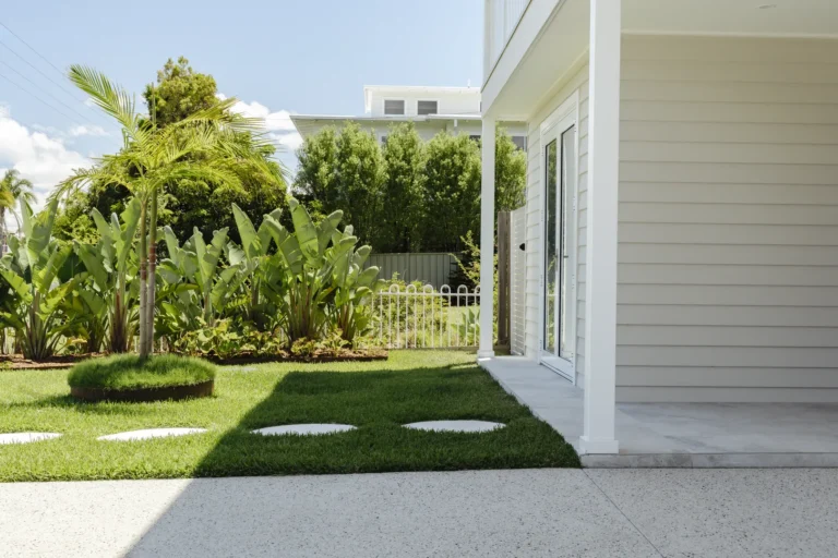 Modern backyard with patio and tropical landscaping