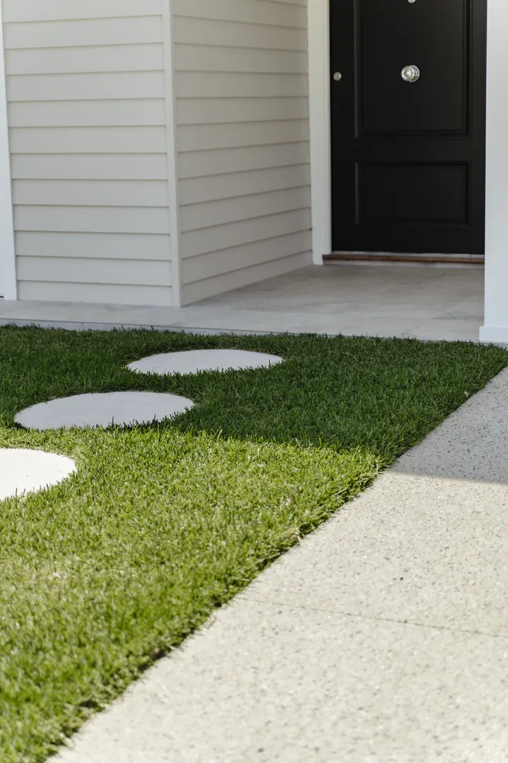 Front porch with stepping stones and black door