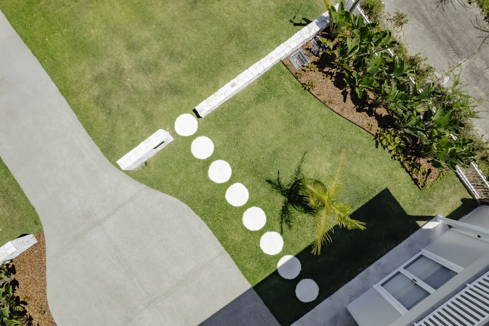 Aerial view of landscaped yard with circular stepping stones