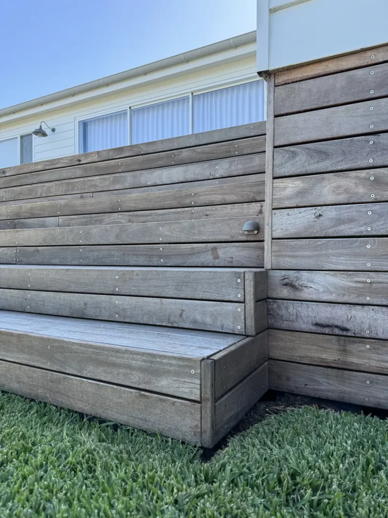 Modern wooden outdoor bench against house exterior