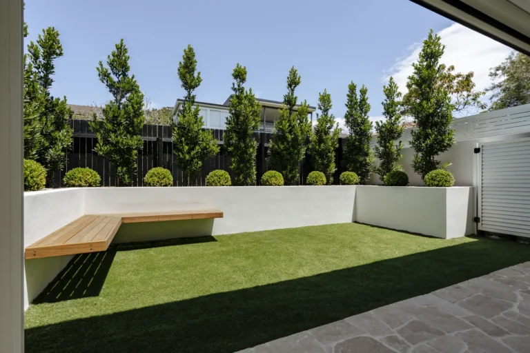 Modern backyard with artificial turf and wooden bench