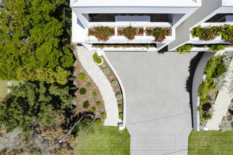 Aerial view of modern home with landscaped driveway